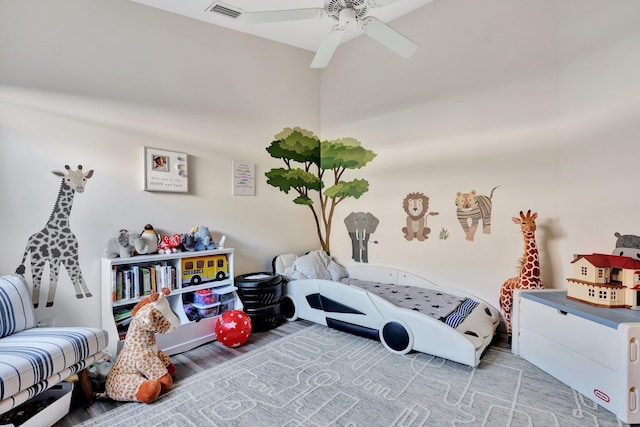 playroom with wood-type flooring and ceiling fan