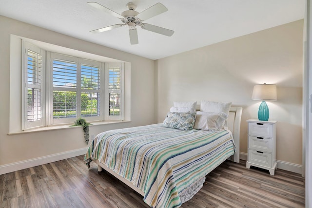 bedroom with ceiling fan and dark hardwood / wood-style floors