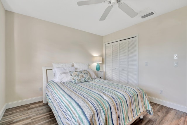 bedroom featuring a closet, hardwood / wood-style flooring, and ceiling fan