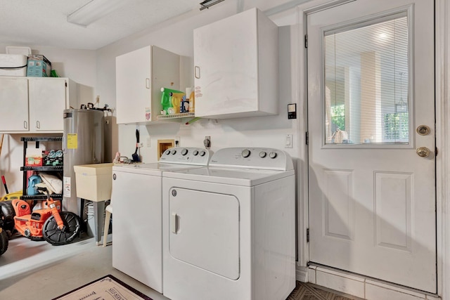 washroom featuring washer and dryer and cabinets