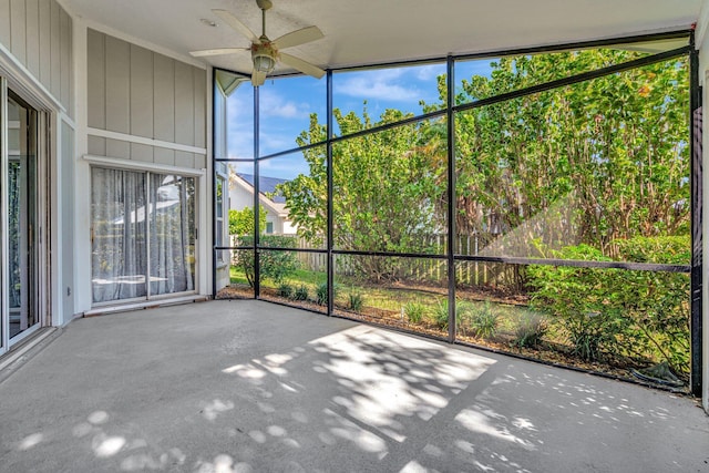 unfurnished sunroom featuring ceiling fan