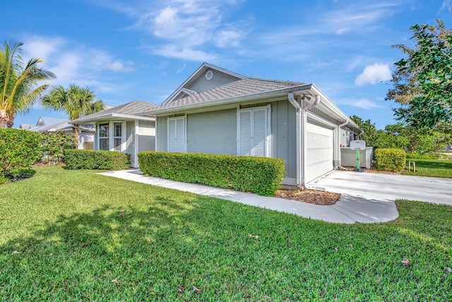 view of front of property featuring a garage and a front lawn