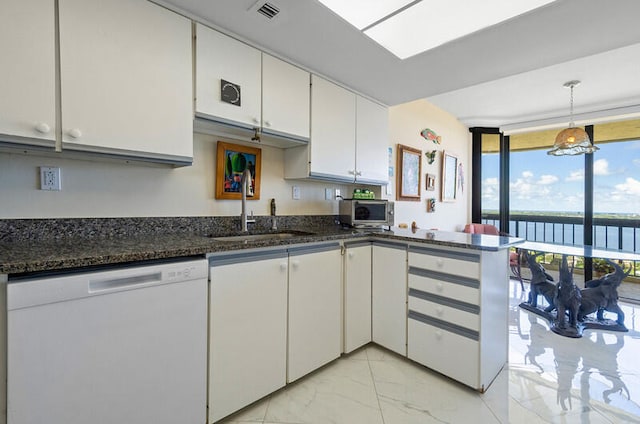 kitchen featuring dishwasher, a water view, sink, dark stone countertops, and white cabinetry