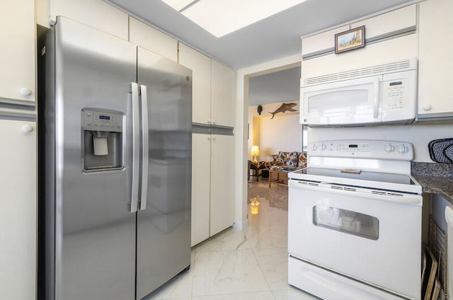 kitchen with white cabinets, white appliances, and dark stone counters