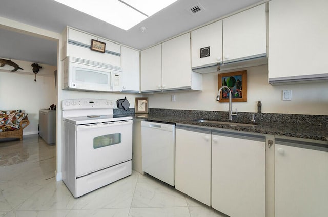 kitchen featuring white cabinets, white appliances, dark stone countertops, and sink