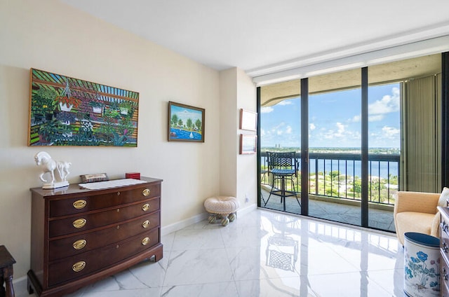 interior space with a water view and floor to ceiling windows