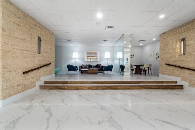 1900 Consulate Pl Unit 1702, West Palm Beach, FL 33401 - community lobby featuring brick wall and recessed lighting