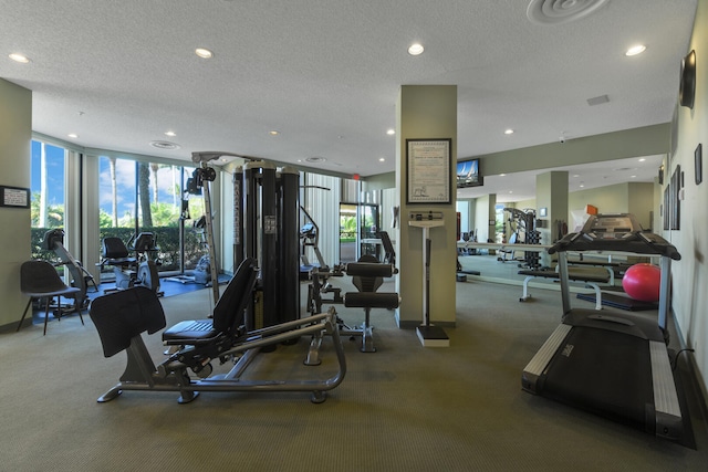 workout area featuring floor to ceiling windows and a textured ceiling