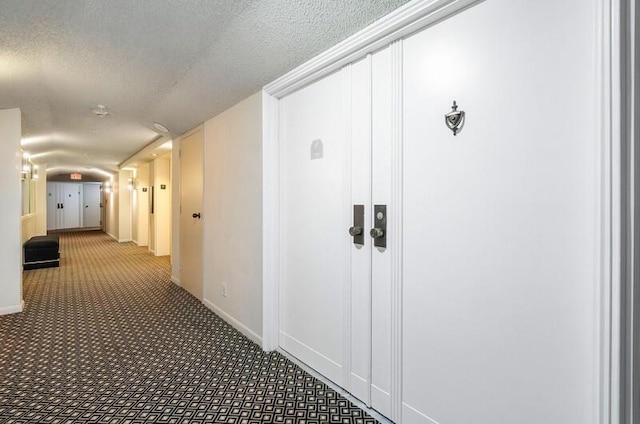1900 Consulate Pl Unit 1702, West Palm Beach, FL 33401 - hallway with carpet, a textured ceiling, and baseboards