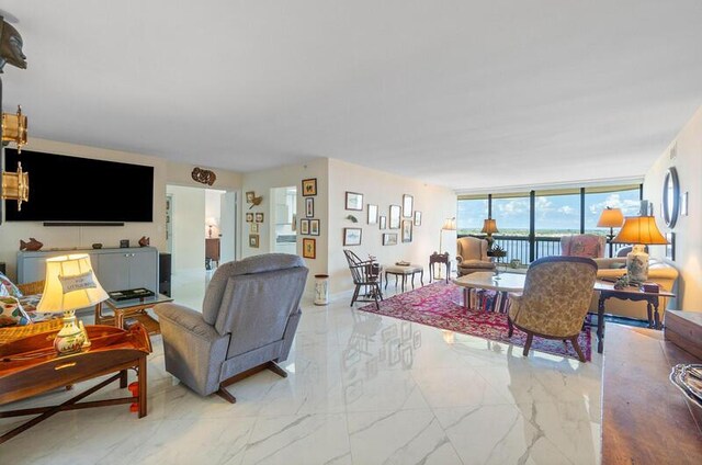 1900 Consulate Pl Unit 1702, West Palm Beach, FL 33401 - living room featuring marble look tile flooring and floor to ceiling windows