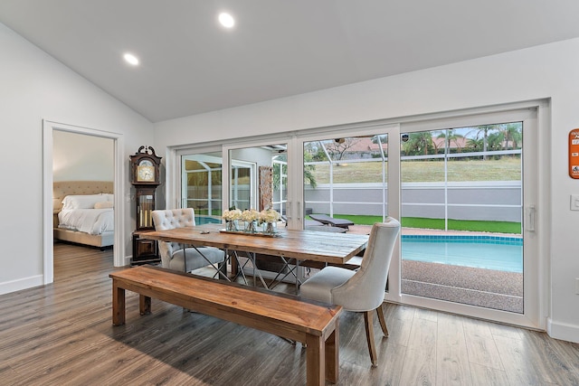 dining space featuring wood-type flooring and lofted ceiling