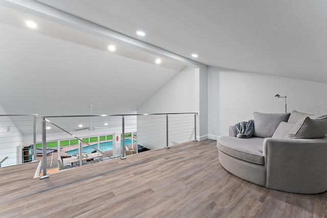 living area featuring hardwood / wood-style floors and vaulted ceiling