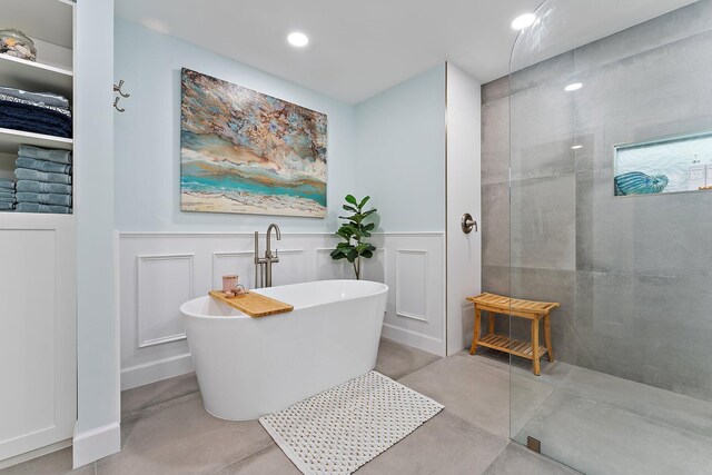 bathroom featuring plus walk in shower and concrete flooring