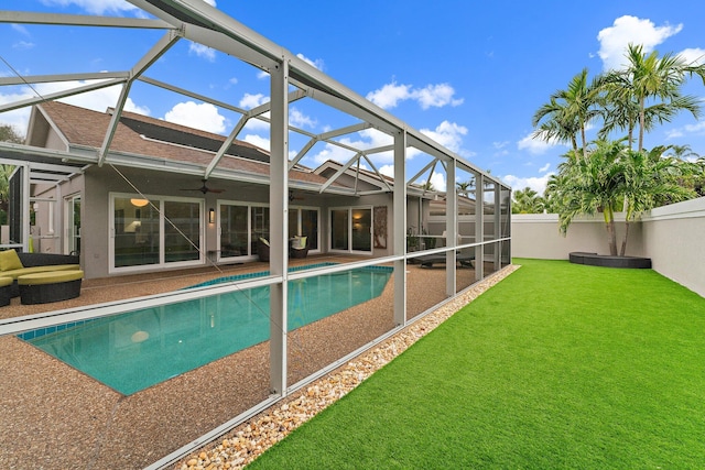 view of swimming pool featuring a lanai and ceiling fan