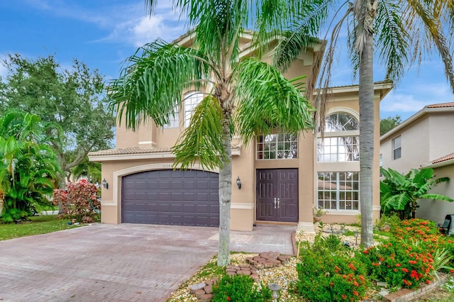 mediterranean / spanish house with a garage