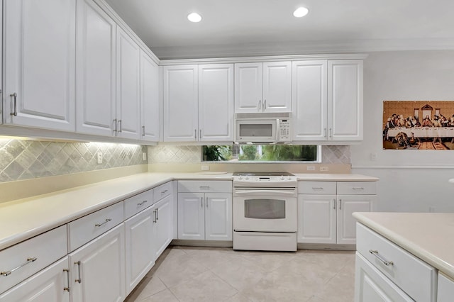 kitchen featuring light tile patterned floors, white cabinets, and white appliances