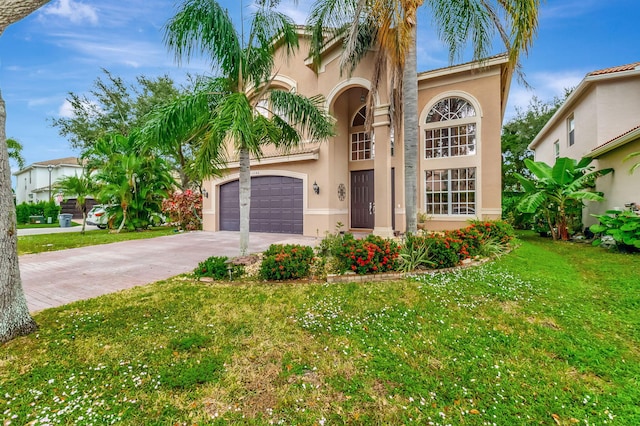 mediterranean / spanish-style home with a garage and a front lawn