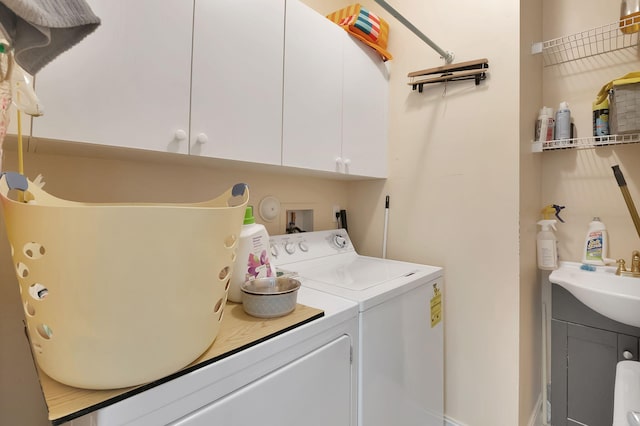 washroom featuring cabinets, separate washer and dryer, and sink