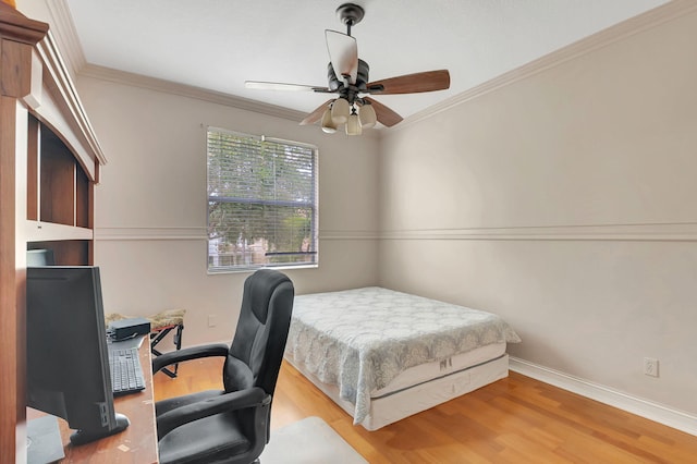 bedroom with hardwood / wood-style flooring, ceiling fan, and ornamental molding