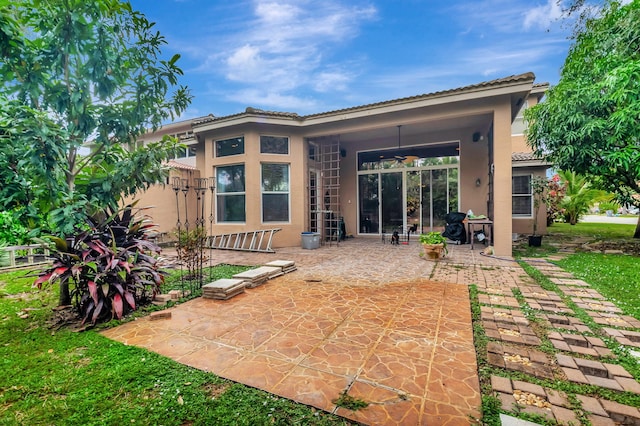 back of property featuring a patio area and ceiling fan