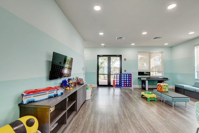 recreation room with french doors and wood-type flooring