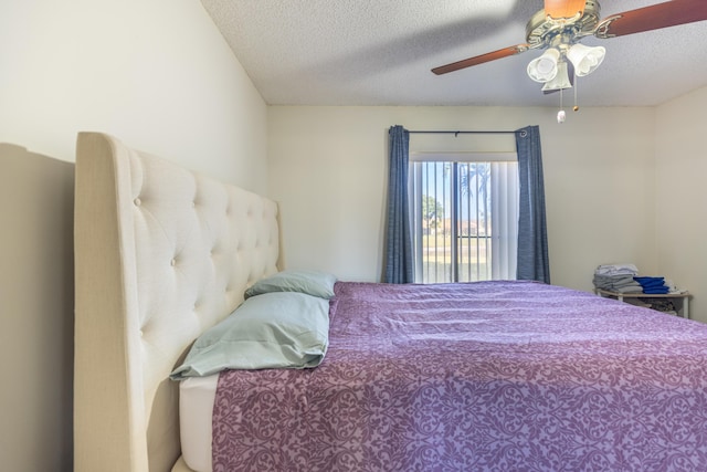 bedroom with ceiling fan and a textured ceiling