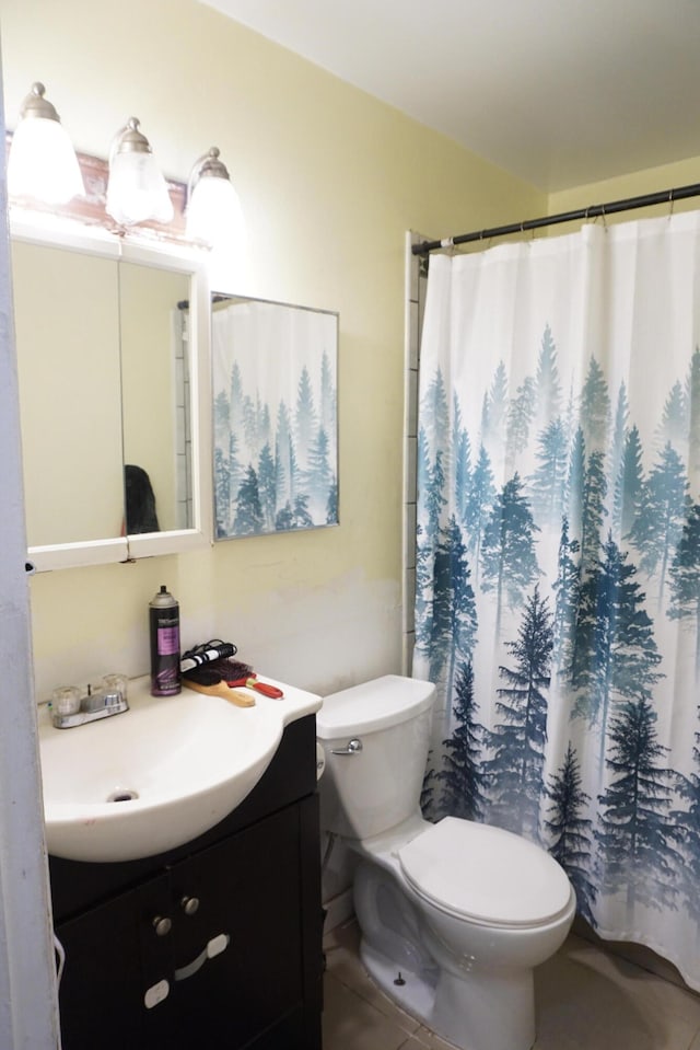 bathroom with tile patterned flooring, vanity, toilet, and a shower with shower curtain