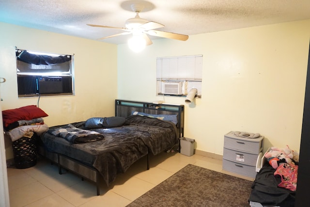 bedroom featuring light tile patterned floors, a textured ceiling, ceiling fan, and cooling unit