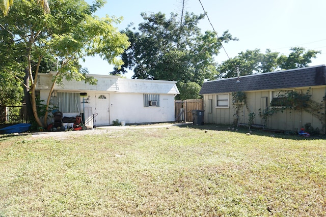 rear view of property with a lawn