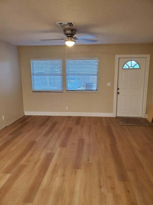 foyer featuring a textured ceiling, hardwood / wood-style flooring, and ceiling fan