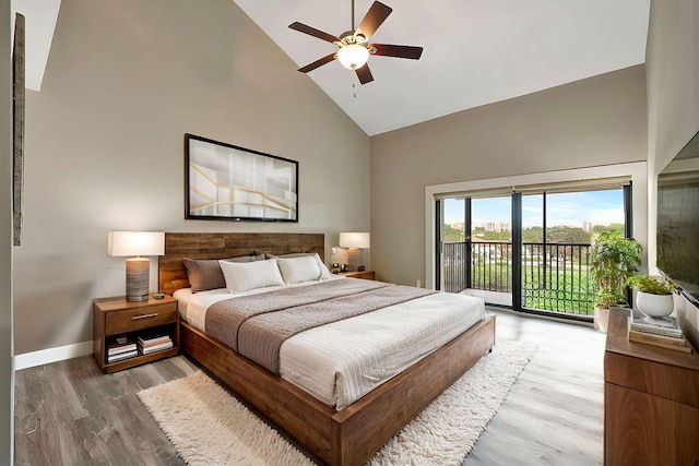 bedroom featuring ceiling fan, access to outside, high vaulted ceiling, and hardwood / wood-style flooring