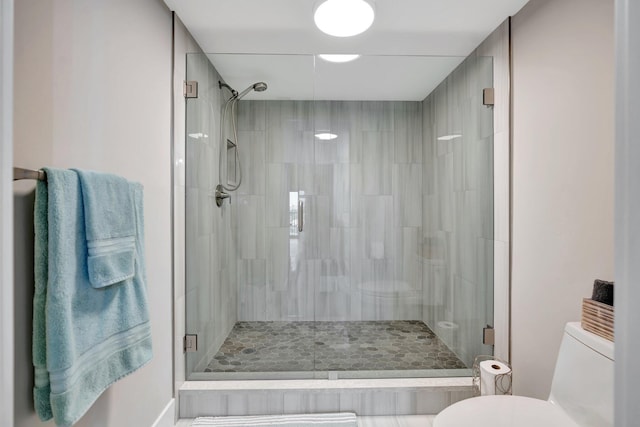 bathroom with an enclosed shower and toilet