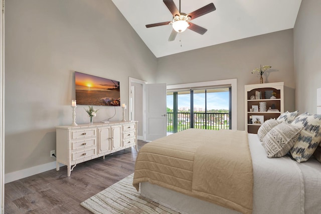 bedroom featuring ceiling fan, dark wood-type flooring, access to outside, and high vaulted ceiling