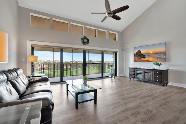 living room with high vaulted ceiling, hardwood / wood-style floors, and ceiling fan