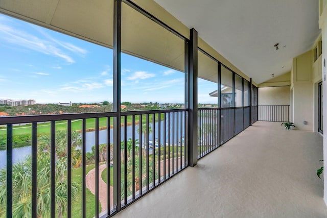 unfurnished sunroom with a water view and vaulted ceiling