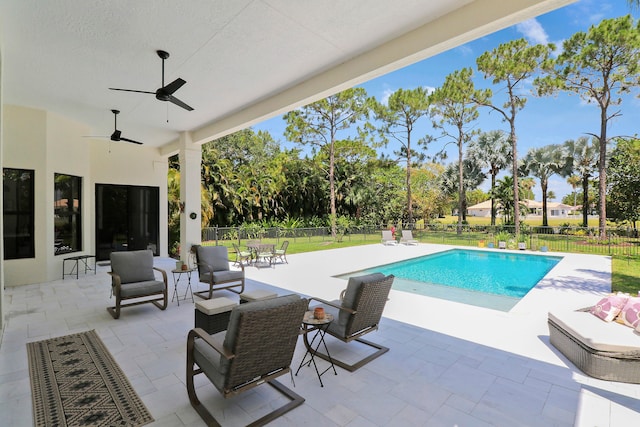 view of swimming pool featuring ceiling fan, a patio area, and an outdoor living space