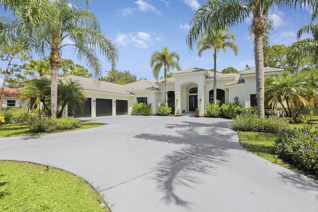 mediterranean / spanish-style house with a garage