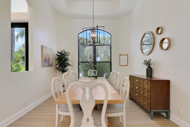 dining area featuring an inviting chandelier and light wood-type flooring