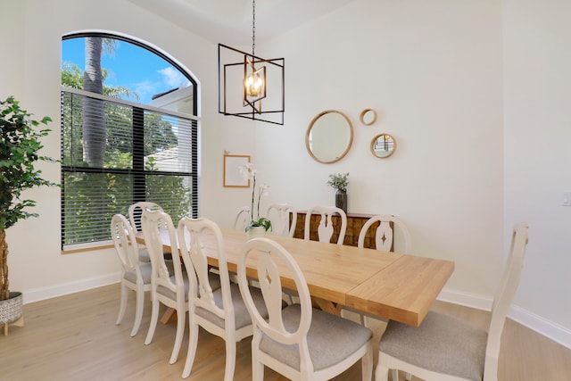 dining room featuring an inviting chandelier, plenty of natural light, and light wood-type flooring