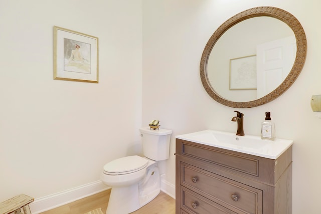 bathroom with vanity, wood-type flooring, and toilet