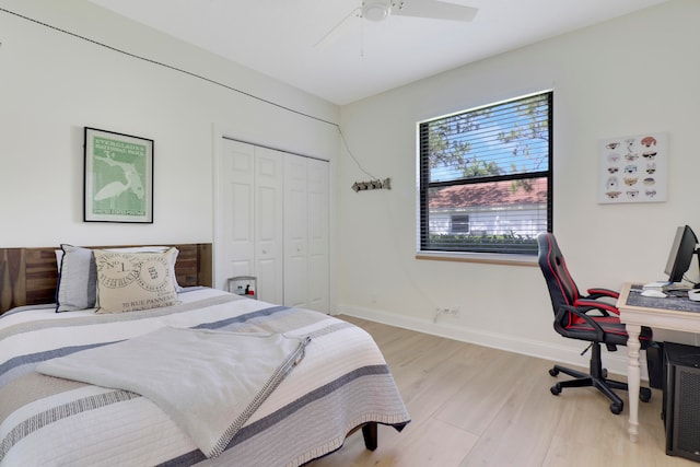 bedroom featuring light hardwood / wood-style flooring, a closet, and ceiling fan