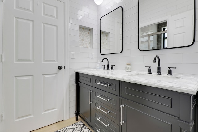 bathroom with vanity, hardwood / wood-style floors, and decorative backsplash