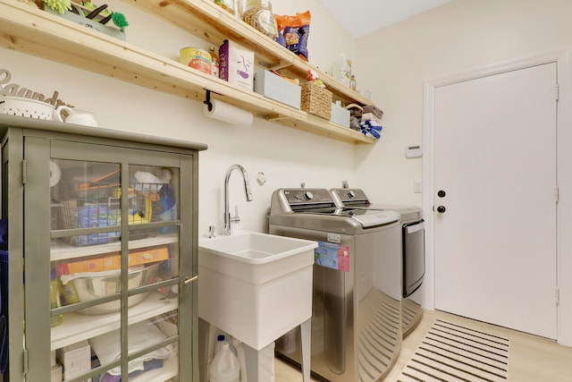 washroom with washer and clothes dryer and sink