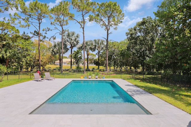 view of swimming pool featuring a yard and a patio area