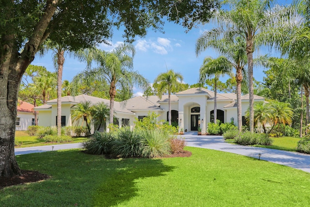 mediterranean / spanish-style house with a front lawn