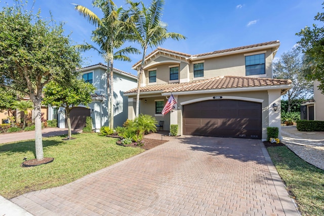 mediterranean / spanish-style house with a front yard and a garage