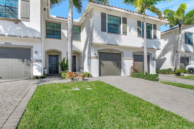 view of front of home featuring a front yard and a garage