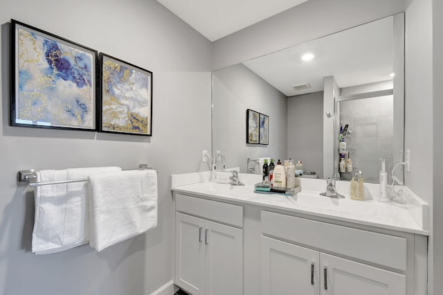 bathroom with vanity and a shower with shower door