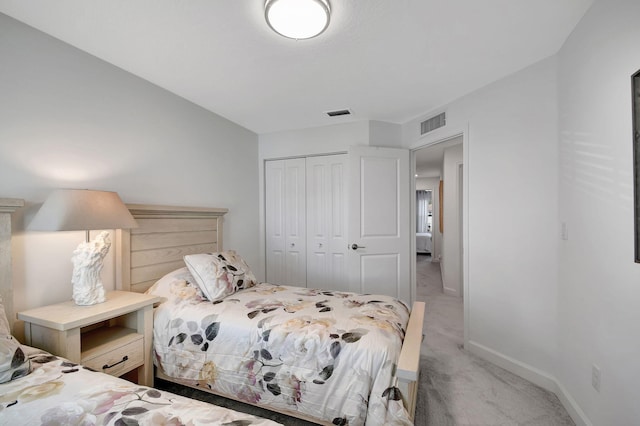 bedroom with a closet and light colored carpet