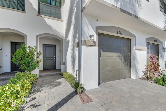 view of exterior entry with a garage